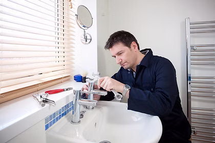 Plumber fixing a tap